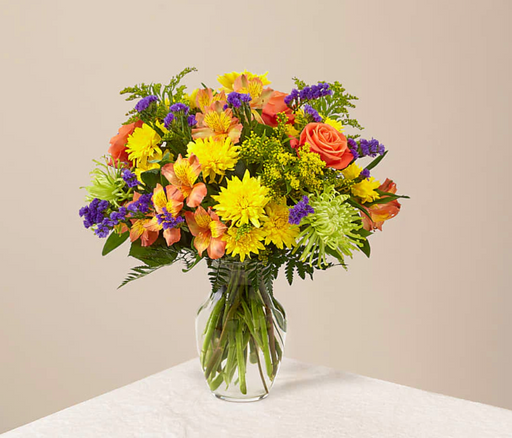 Flowers of yellow, blue, and green, and pops of orange and purple. Full of color and texture, all you need is love and our Texas Prairie Bouquet.